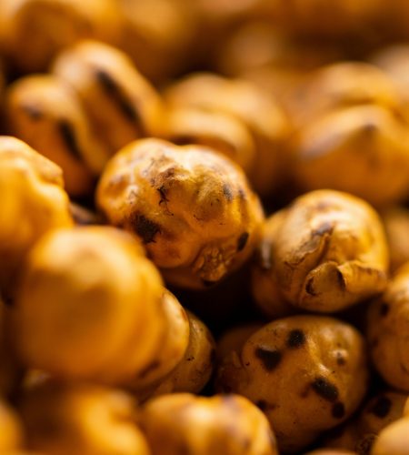 Macro shot of roasted chickpeas showcasing texture and warm hues.