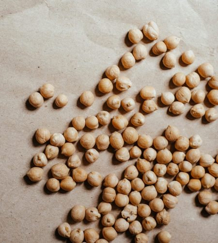 Nutritious chickpeas scattered on brown paper, ideal for food photography.